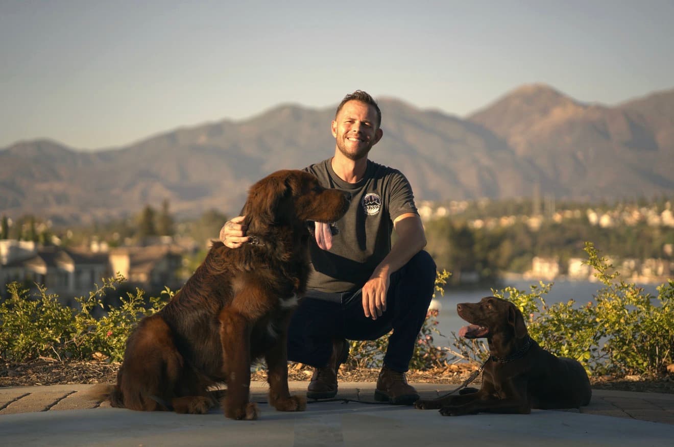 Jake with two calm, well-trained dogs at golden hour in Orange County